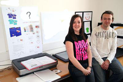 Graphic design students Michelle Tooke and Stefan Strichen with their logo designs for Radio Addenbrooke’s